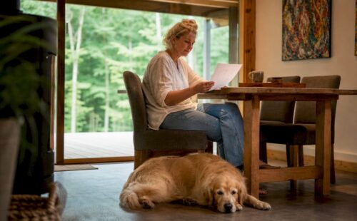 Vrouw bekijkt samen met haar hond haar reservering